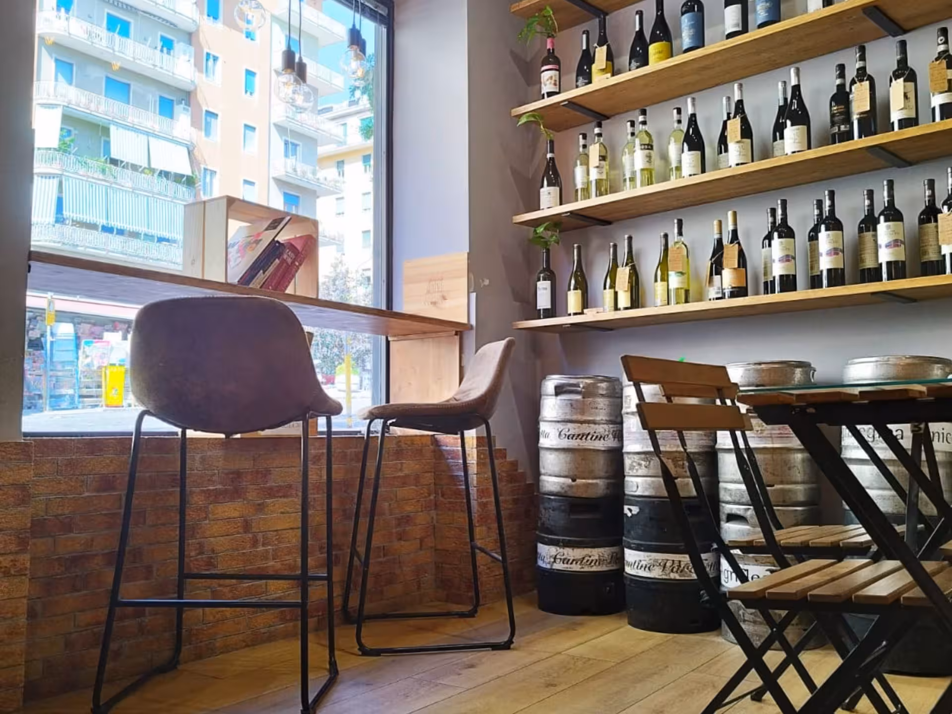 Cozy Naples wine bar with wooden shelves displaying diverse wine bottles and rustic seating for tastings.