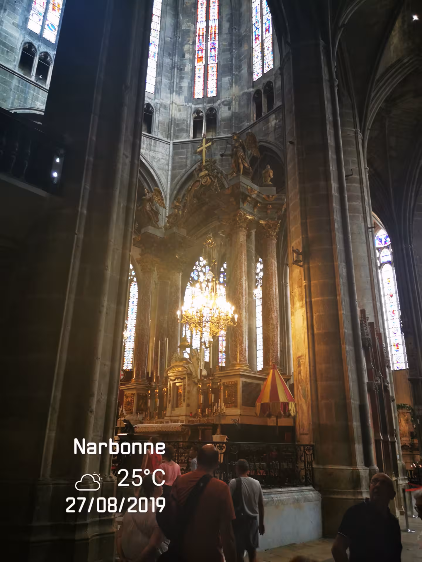 Narbonne Cathedral altar and chandelier beneath stained glass on a private Sète shore excursion to Narbonne