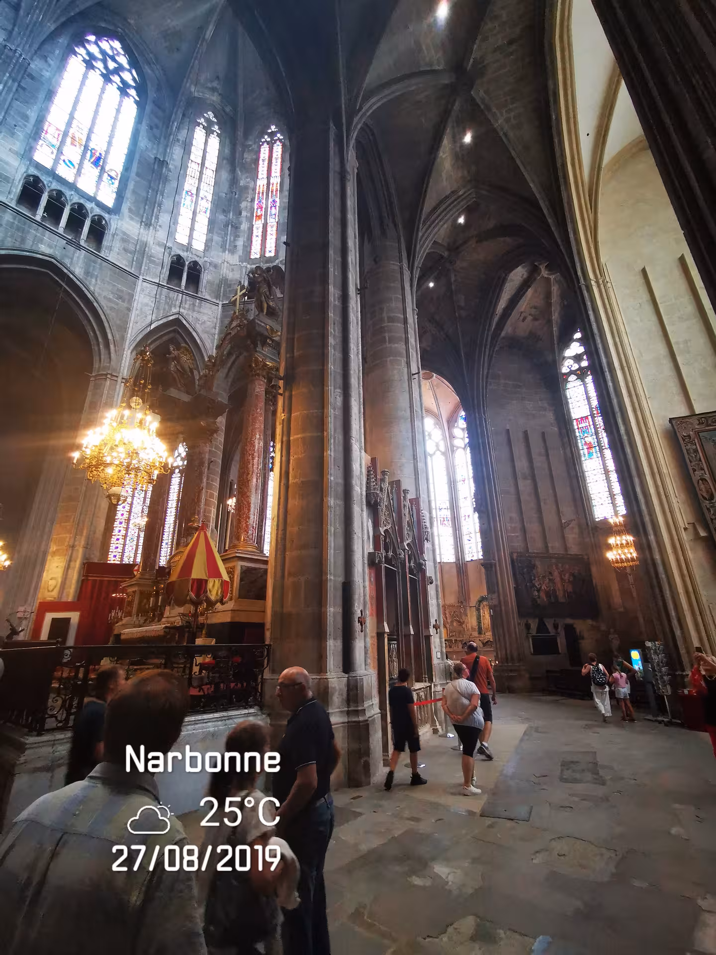 Inside Narbonne Cathedral with soaring Gothic arches and stained glass on a private shore excursion from Sète