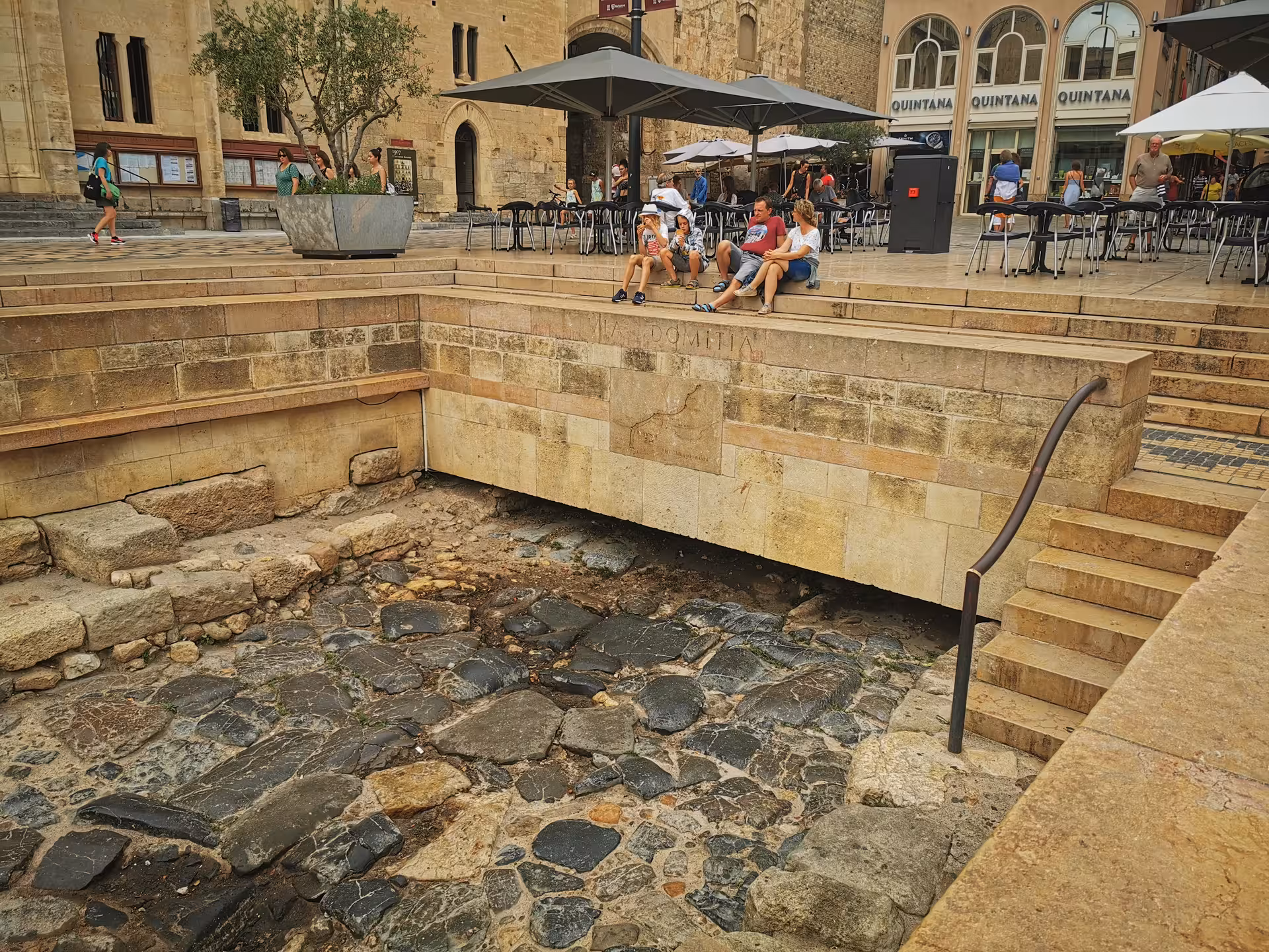 Narbonne Roman Via Domitia ruins beside café terrace, visited on private shore excursion from Sète to Carcassonne