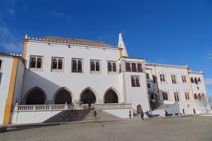 Explore the grand facade of the National Palace of Sintra, showcasing stunning architecture and history.