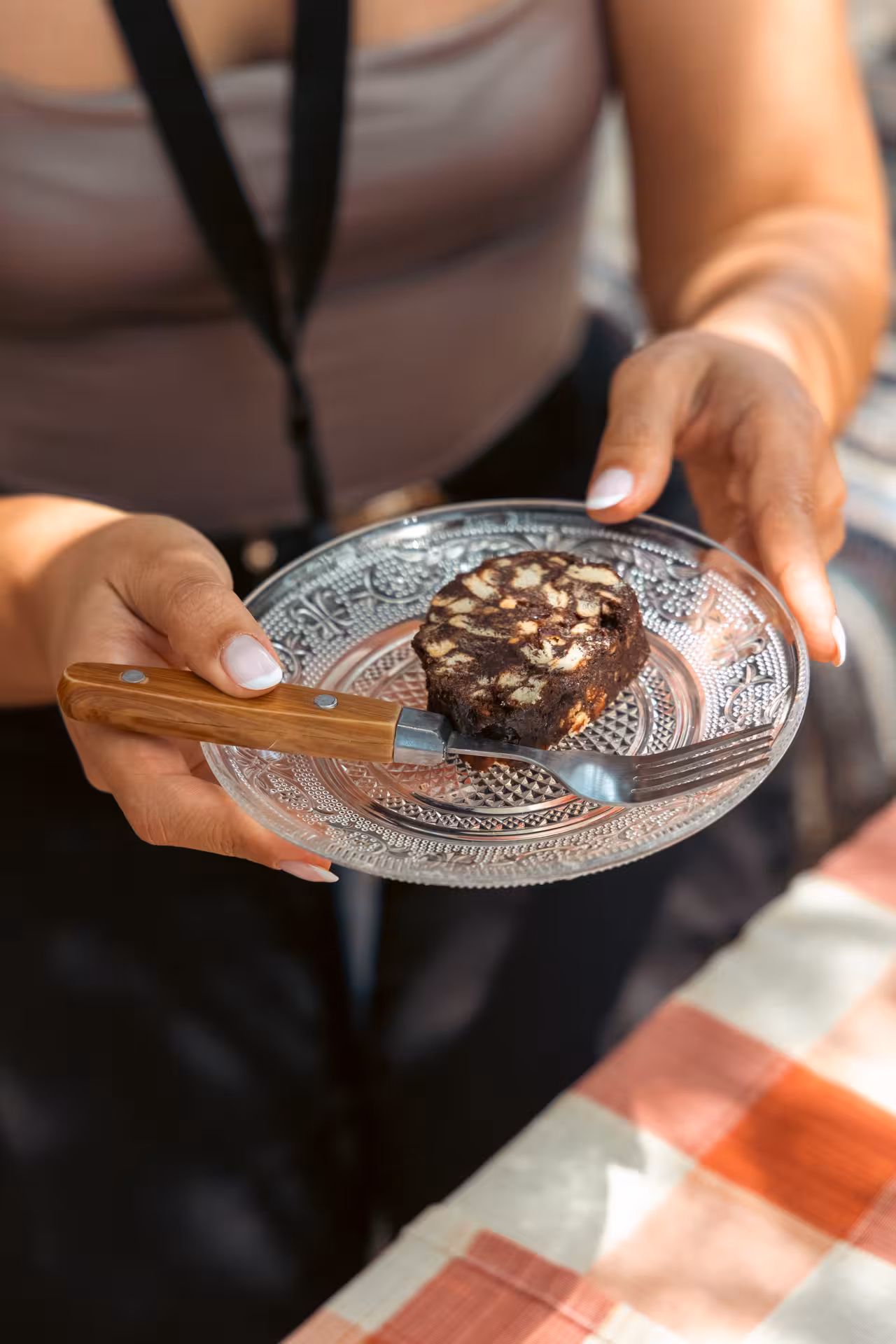 Serving a homemade Greek chocolate salami dessert after the Naxos traditional cooking and cheesemaking class