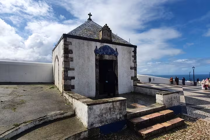 Charming historic chapel in Nazaré with scenic ocean views, part of the Fátima, Batalha, and Óbidos small-group tour from Lisbon.