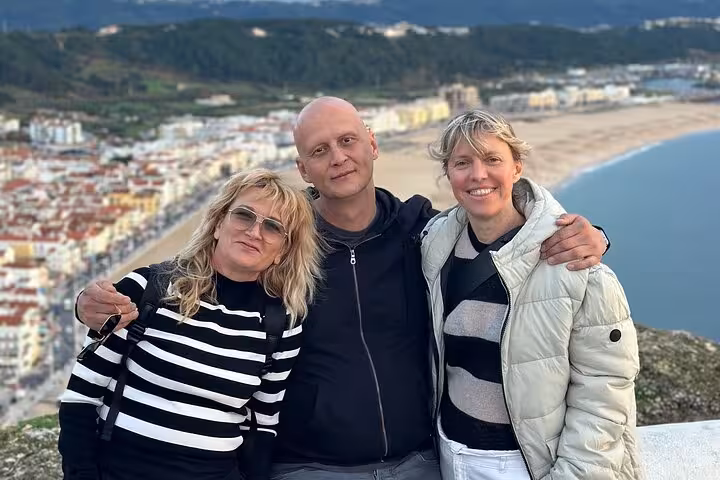 Group enjoying the stunning coastal view at Nazare during a private car tour.