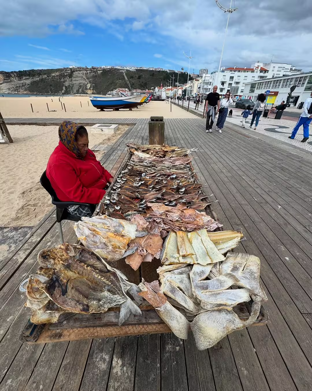 Traditional fish drying stall on Nazaré beach with scenic views, capturing local culture near the famous giant waves surfing spot.