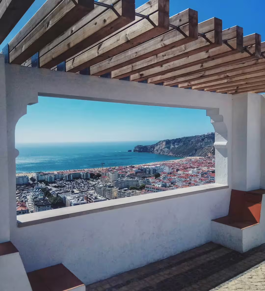 View of Nazaré's coastline and cliffs through a scenic terrace, perfect for experiencing Portugal's famous giant waves.