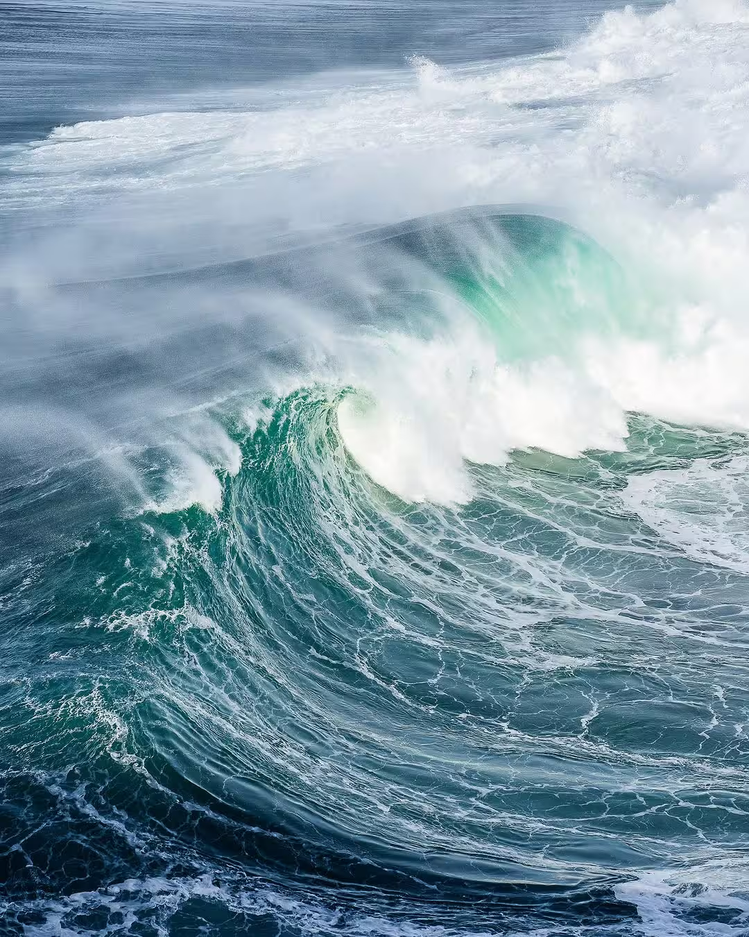 Massive, powerful wave crashing in Nazaré, Portugal, showcasing the thrilling giant surf experience for adventure seekers.