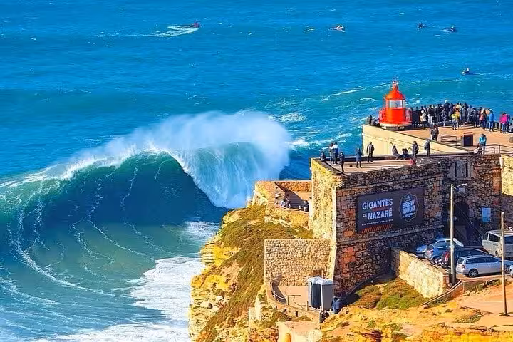 Spectacular view of Nazare's iconic lighthouse with massive waves, perfect for private tours exploring Portugal's coastline.