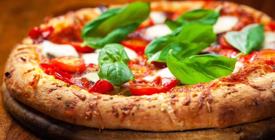 Close-up of authentic Neapolitan Margherita pizza with basil, tomato and mozzarella served on a Naples food tour