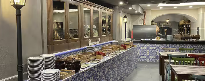 Neapolitan kitchen buffet and tiled counter inside Naples pizzeria, prep area for hands-on pizza lesson
