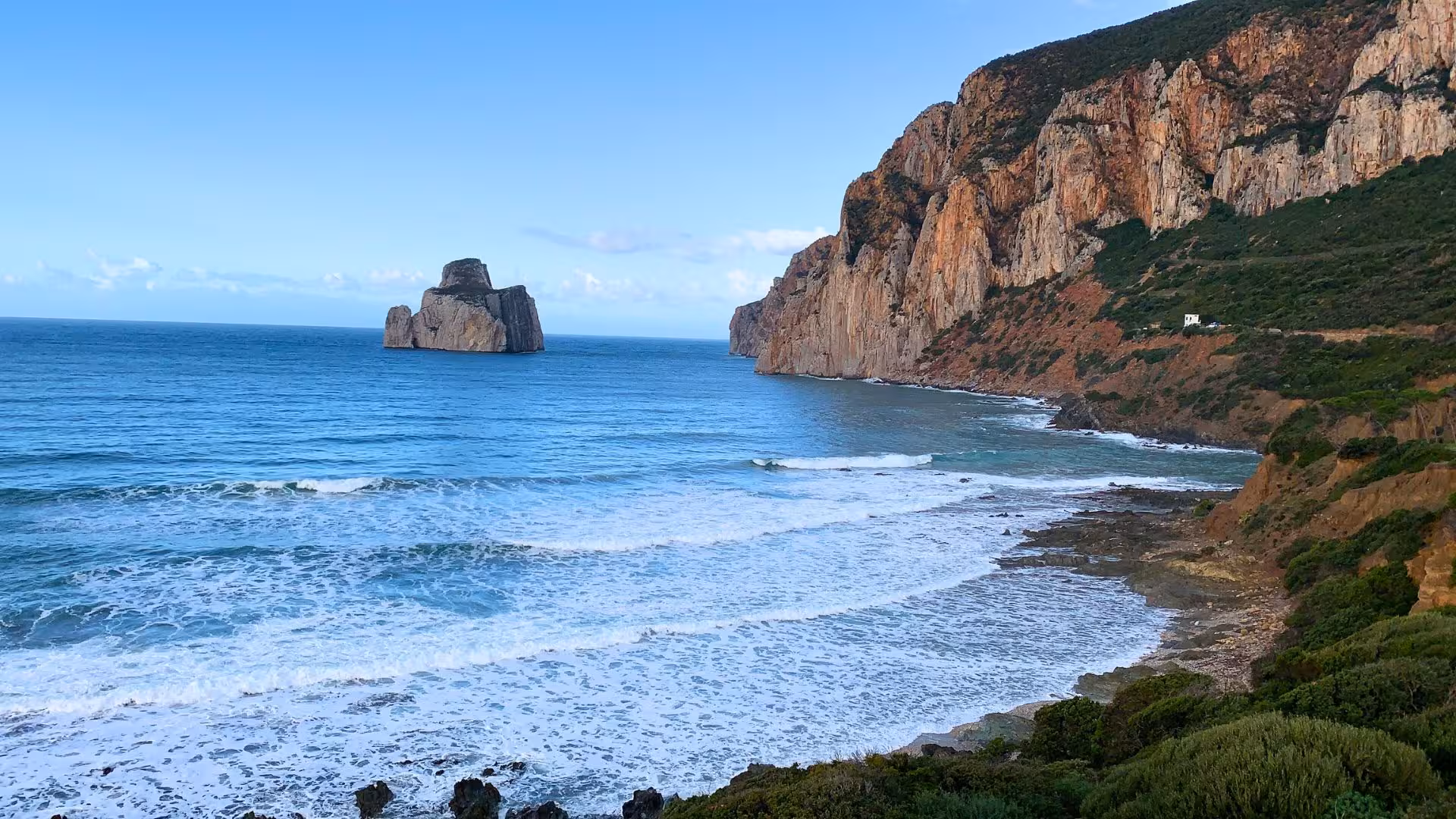 Dramatic sea cliffs and ocean waves along the Nebida to Masua hiking route, showcasing Sardinia's stunning coastal landscape.