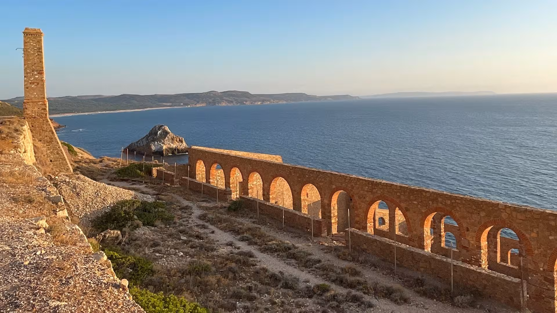 View of ancient ruins along the Nebida to Masua hiking trail overlooking the Mediterranean Sea, perfect for panoramic views.