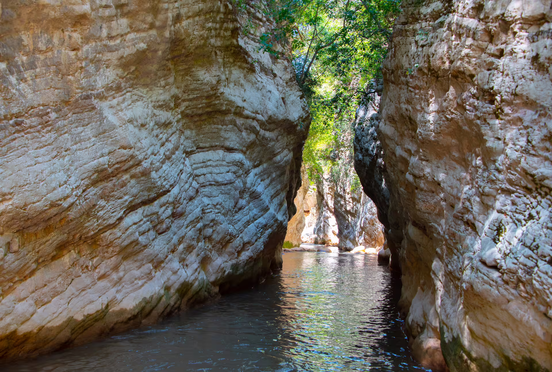 Neda River canyon passage with clear water between towering cliffs, scenic river trekking route