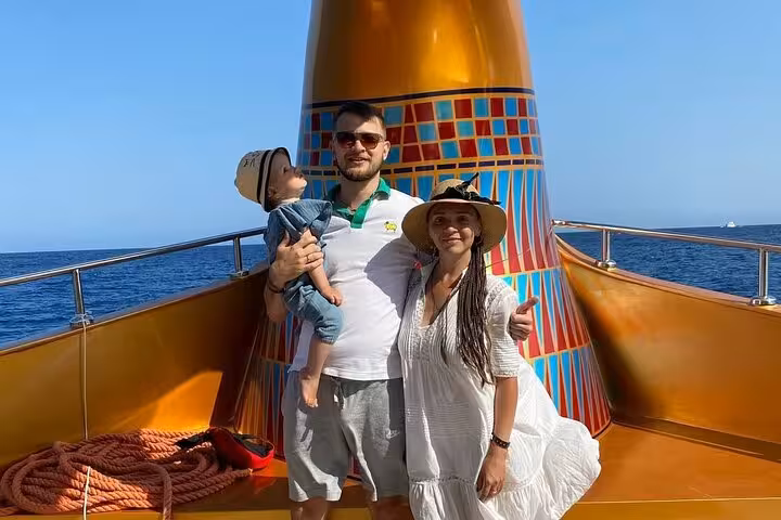 Family on Nefertari cruise deck in Red Sea, Makadi pickup snorkeling tour with glass-bottom boat views