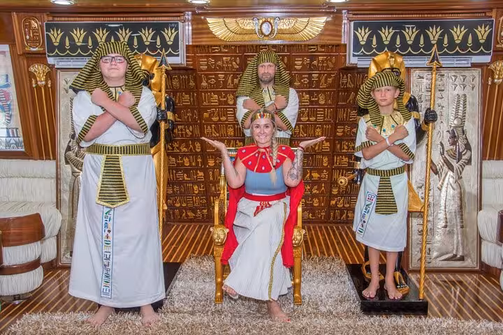 Tourists pose in pharaoh costumes on Nefertari snorkeling cruise from Makadi with hotel pickup photo stop