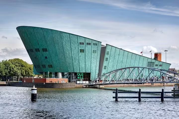 Futuristic design of NEMO Science Museum along Amsterdam's waterfront, featured in private 2-hour tours.
