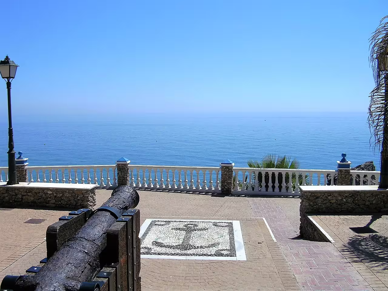 Nerja seaside terrace with historic cannon and Mediterranean views, on private Nerja and Frigiliana tour from Marbella