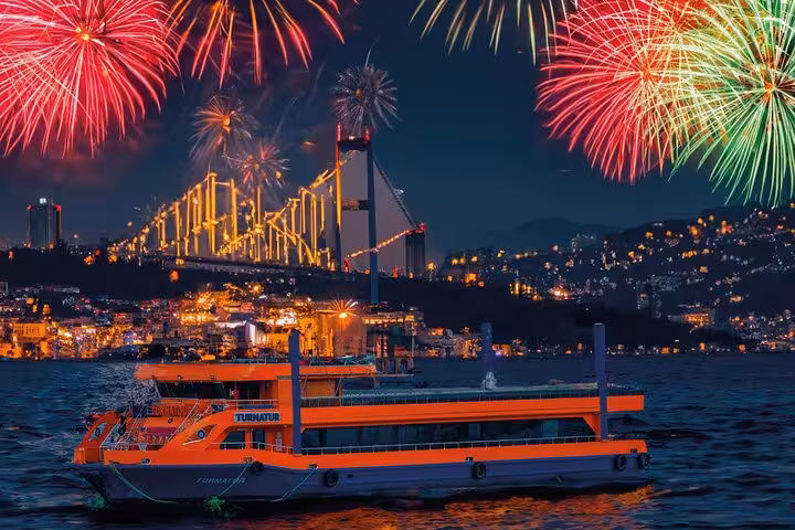Fireworks over Bosphorus Bridge and party boat on Istanbul New Year's Eve cruise with city lights