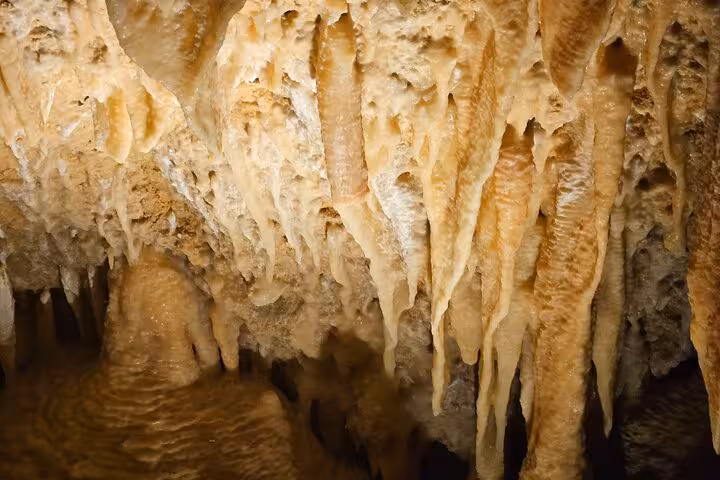 Stunning stalactites in Ngilgi Cave on the 2 Day Busselton Jetty tour, showcasing natural limestone formations.