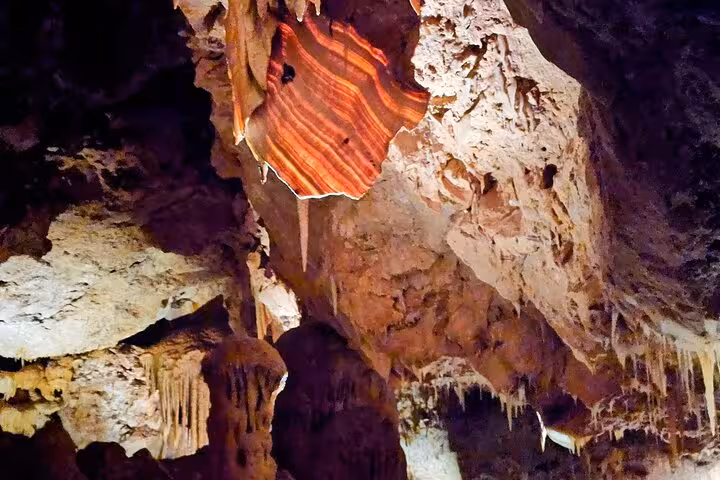 Close-up of colorful stratified rock formations inside Ngilgi Cave on the Busselton tour.