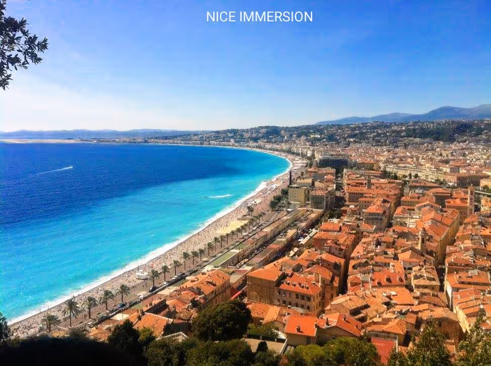 Stunning aerial view of Nice's azure coastline and charming rooftops, perfect for a French Riviera getaway.
