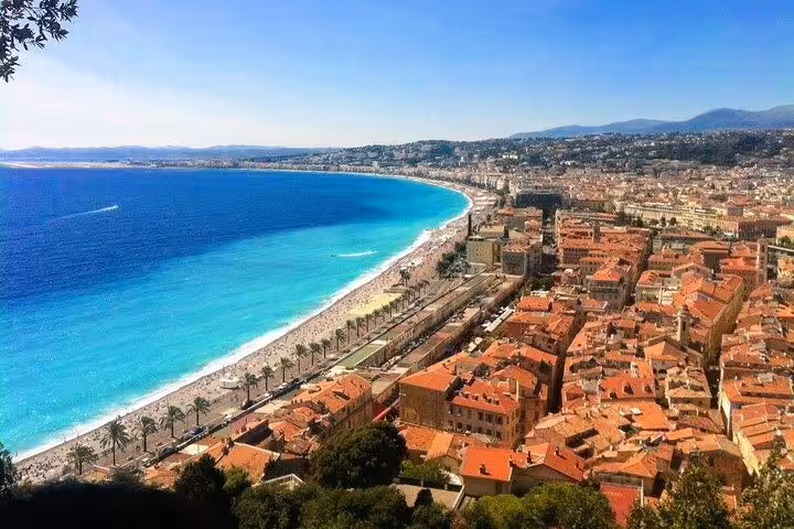 Aerial view of Nice's vibrant coastline with azure waters, sandy beaches, and charming Mediterranean architecture.