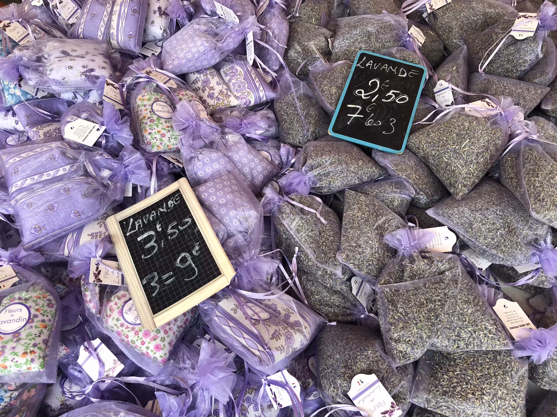 Lavender sachets and dried flowers on display at Nice market, offering aromatic souvenirs for food and wine enthusiasts.