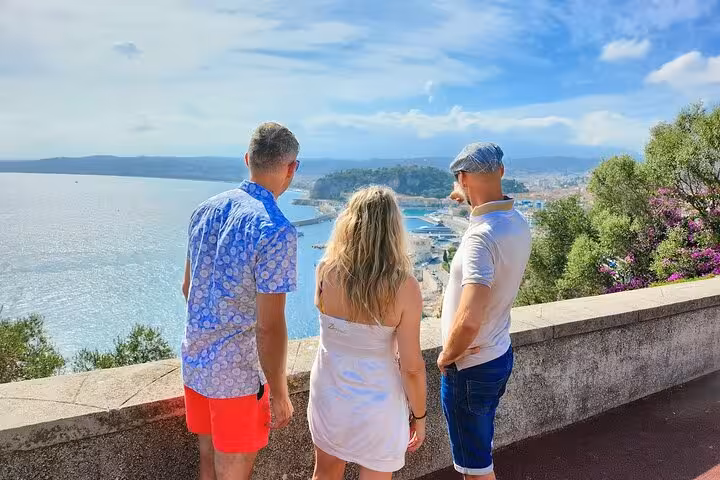 Tourists enjoy panoramic views of Nice's coastline under a bright blue sky during a private guided tour.