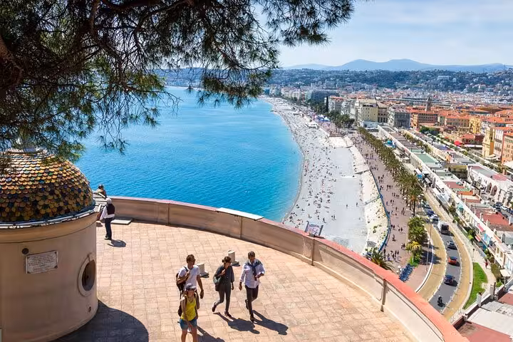 Stunning view of Nice's Promenade des Anglais with turquoise waters and bustling beachfront, ideal for a private tour.