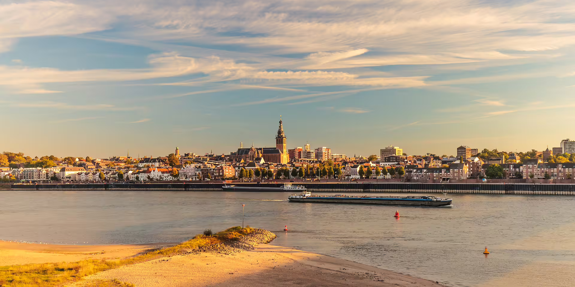 Nijmegen skyline over the Waal River at sunset, key stop on the 1-day walking tour with audioguide
