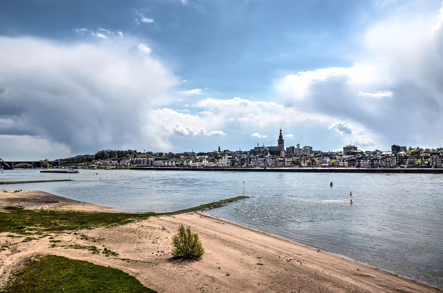 Waal River view of Nijmegen waterfront and skyline, scenic highlight on the 1-day walking tour audioguide