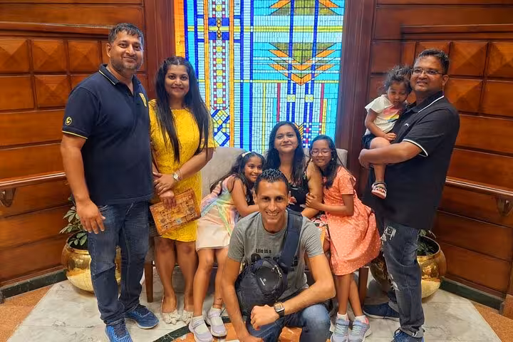 Family smiles together on a Nile cruise, enjoying a colorful live show experience.