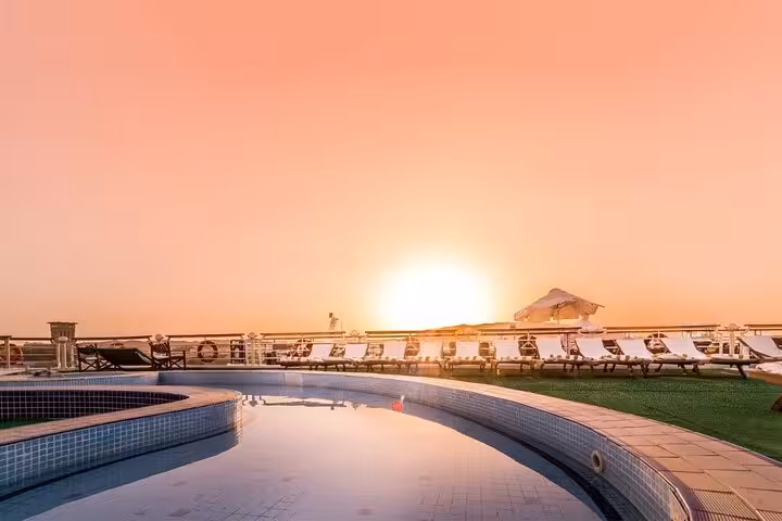 Sunset view of Nile cruise ship pool deck in Luxor, relaxing stop on 5-day Luxor to Aswan cruise