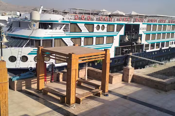 Nile cruise ship moored by riverside promenade in Cairo, featured on 8-day Egypt pyramids and cruise tour