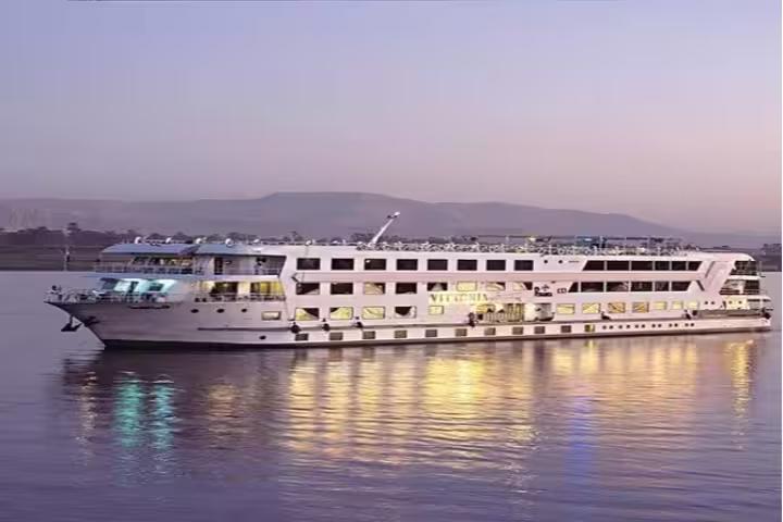 Luxury Nile cruise ship sailing at sunset in Egypt, part of the 8-day pyramids and Nile cruise by air tour