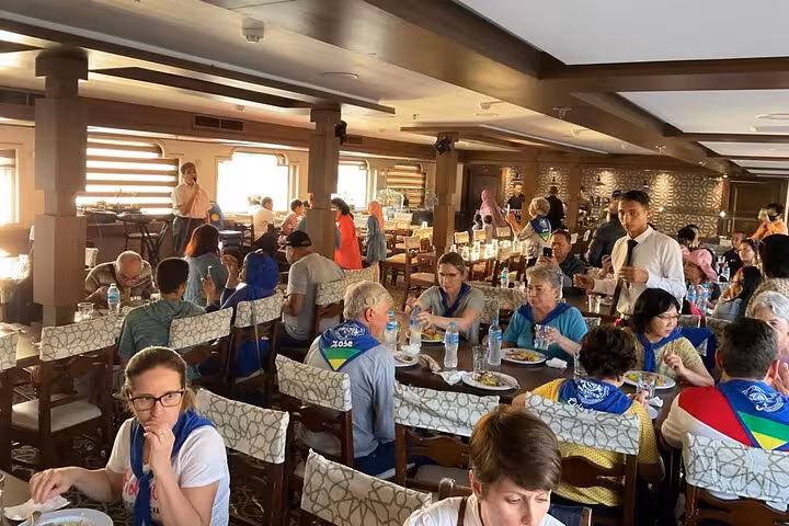 Guests dining inside a Nile dinner cruise boat in Cairo, enjoying buffet meal before belly dance show