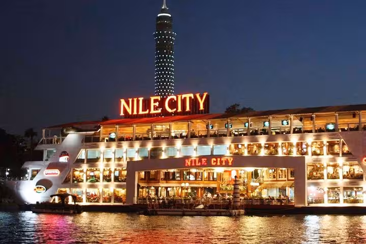 Nile City dinner cruise boat lit up at night on the Nile in Cairo, Egypt, with onboard dining and show