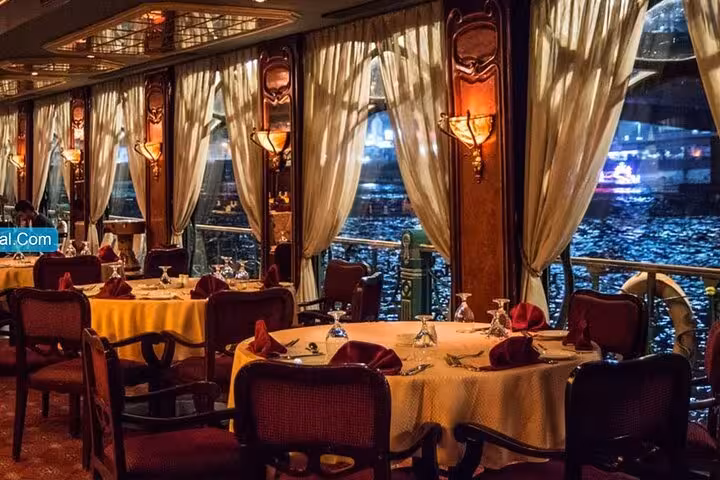Elegant Nile dinner cruise dining room with river views in Cairo, buffet meal and live oriental dance entertainment