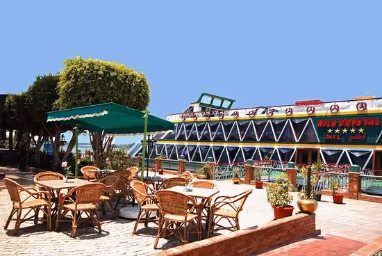 Outdoor seating beside Nile dinner cruise in Cairo, pre-boarding lounge for buffet and belly dancing with transfer