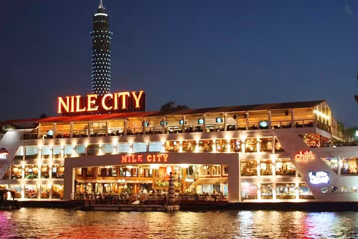 Nile City dinner cruise boat glowing at night in Cairo, perfect for stars, buffet dinner and oriental dance show