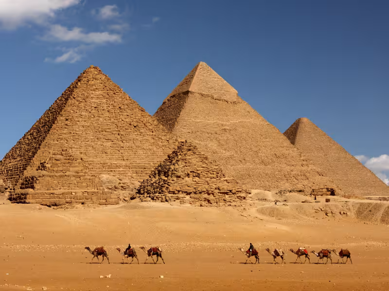 Camel caravan in front of the Giza Pyramids, Cairo excursion included with the 5-star Nile Jewel cruise