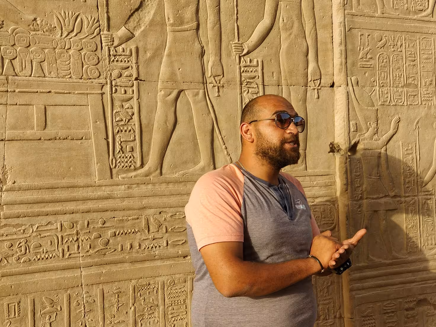 Egyptologist guide explaining ancient hieroglyphs at a Nile temple on Nile Pearl 5-star Nile cruise tour