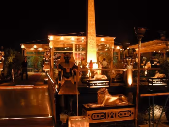 Night view of Pharaohs Nile cruise deck with obelisk and sphinx decor, luxury Egypt river cruise booking