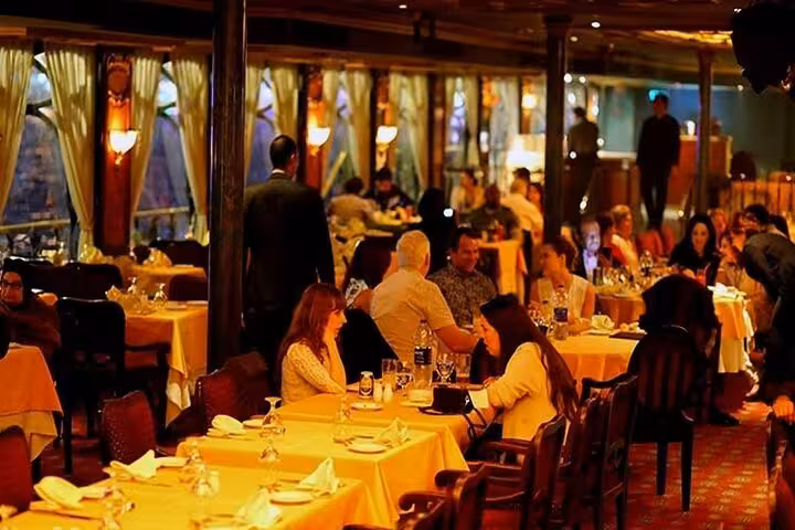 Elegant dining room on a Nile River dinner cruise in Cairo with set tables and evening river views