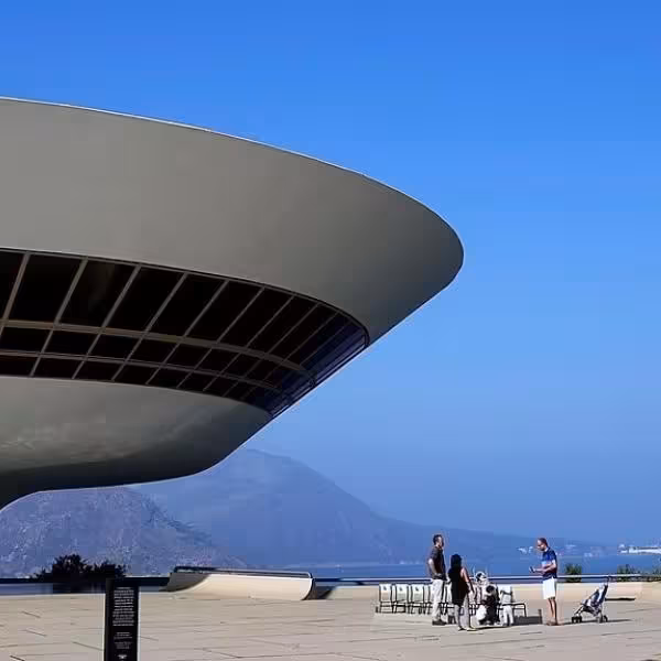 The iconic Niterói Contemporary Art Museum with tourists enjoying the breathtaking views of the surrounding landscape.