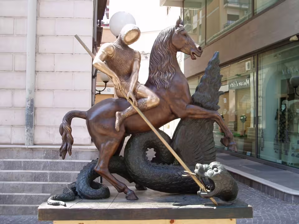 Modern bronze statue of a Norman knight spearing a dragon in central Cosenza, Italy, on the Byzantines and Normans tour