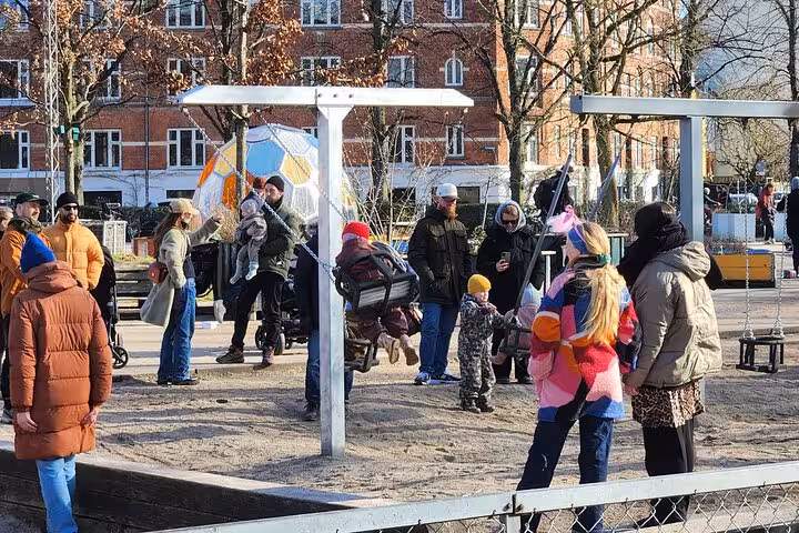Families gather at a lively Copenhagen playground, showcasing community life and Danish outdoor culture.