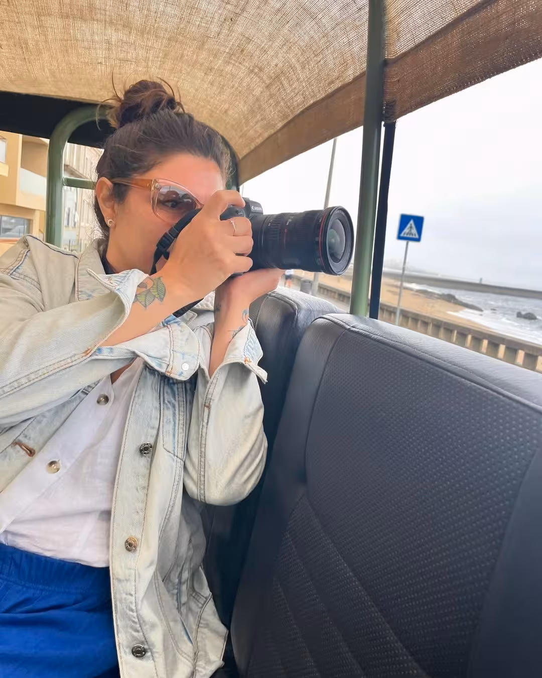 Guest photographing seabirds from an open-air vehicle on the North Coast Birdwatching Adventure tour