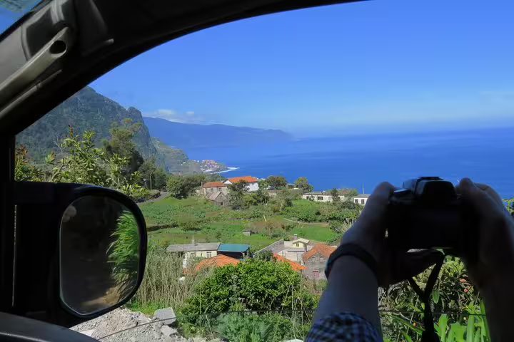 Capturing panoramic views of Madeira's lush landscape and ocean on a Northeast 4x4 tour stop.