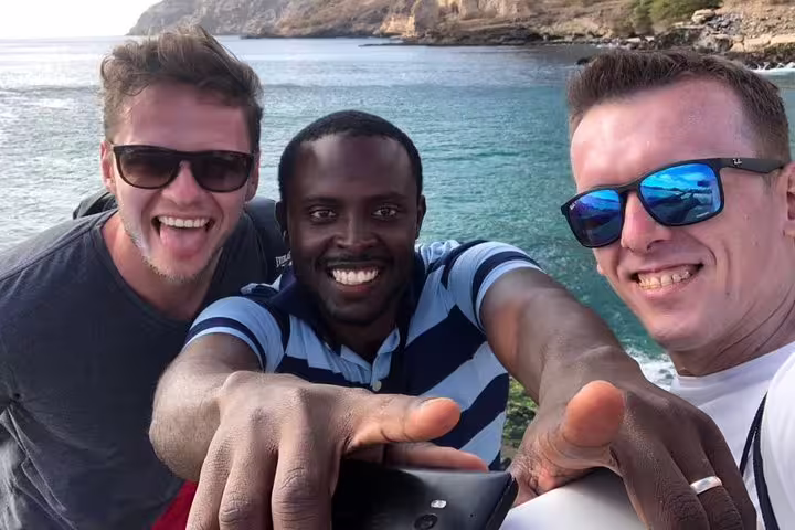 Group of friends enjoying the scenic coastline on the Full-day Lagoa Natural Pool tour.
